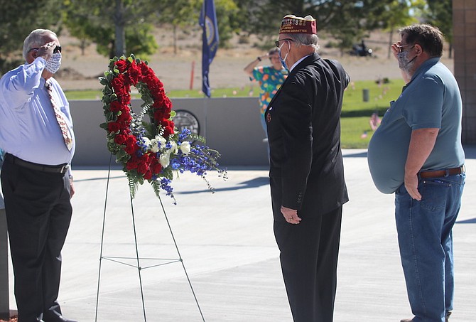 From left, Jerry Findley, Bill Baumann and Roy Edgington salute after a wreath is placed at the Northern Nevada Veterans Memorial Ceremony as part of the Memorial Day observance.