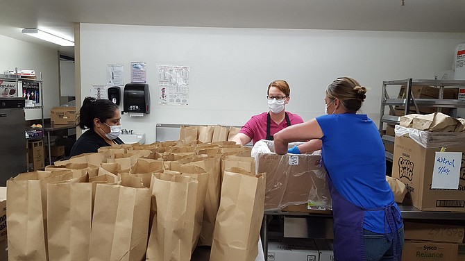 Nutrition services staff members prepare ready-to-serve meals. 