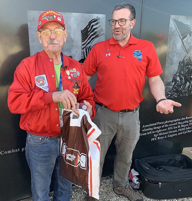 Ken Santor holds a bag of Tootsie Rolls after Jon Yuspa, right, executive director of Honor Flight Nevada, surprised the Korean War veteran and persuaded him to tell the story of the password Tootsie Roll.