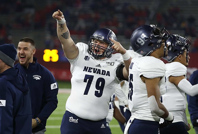 Nevada offensive lineman Moses Landis celebrates a long drive against Fresno State during the second half of an NCAA college football game in Fresno, Calif., Saturday, Nov. 23, 2019. 