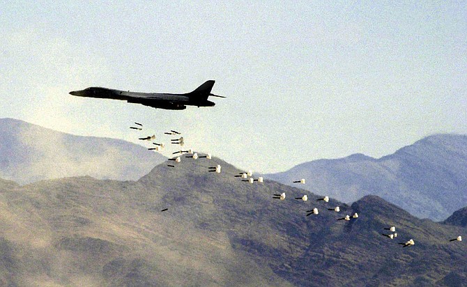 FILE - In this Friday, July 19, 2002, file photo, a U.S. Air Force B1-B bomber drops live bombs at the Nevada Test and Training Range in Indian Springs, Nev. Nevada&#039;s congressional Democrats gained backing from Gov. Steve Sisolak in a bid to block a measure to let the military widen boundaries of a vast U.S. Air Force bombing range in southern Nevada into a national wildlife refuge. The governor, a Democrat, joined U.S. Representatives Dina Titus, Steven Horsford and Susie Lee on Thursday, July 9, 2020, citing opposition to the idea by groups including the Moapa Band of Paiutes and the Las Vegas Paiute Tribe. 