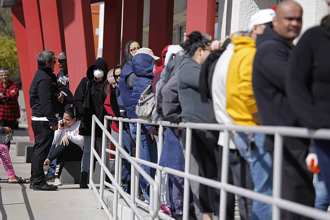 People wait in line for help with unemployment benefits at the One-Stop Career Center in Las Vegas on March 17, 2020. (Associated Press photo)