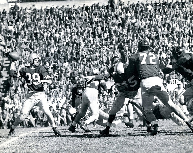 Stan Heath passing under pressure from Santa Clara linemen during the 1948 game. Blocking are Tommy Kalmanir (24) and Sherman Howard (45).