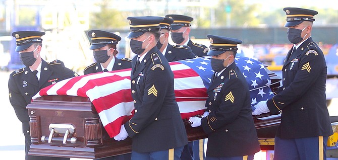 An honor guard from the Nevada Army National Guard carries a casket holding the remains of Lt. Lowell Twedt. He was shot down over the Italian Alps on October 20, 1944. His body was discovered in 2017 and positively identified in 2019. His body returned to Reno, Nev., Friday night, July 31, 2020, to his family.