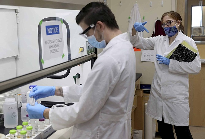 UNLV professor Elisabeth &quot;Libby&quot; Hausrath works with Ph.D. student Anthony Feldman in her lab on campus in Las Vegas Friday, July 24, 2020. Hausrath is one of 10 scientists selected by NASA to study the soil and rock samples from Mars. (K.M. Cannon/Las Vegas Review-Journal via AP)