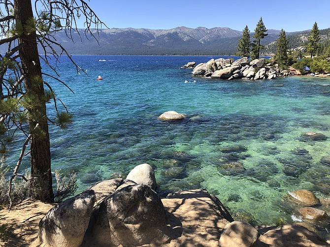 This photo taken July 13, 2020 at Lake Tahoe Nevada State Park shows a stretch of the lake&#039;s northeast shore looking north from Sand Harbor toward Incline Village, Nev.  Lake Tahoe&#039;s fluctuating clarity took a dive last year, worsening by about 8 feet during an especially cold and wet winter as sedimentation, algae growth and a tiny invasive shrimp continue to pose restoration challenges. (AP Photo/Scott Sonner).