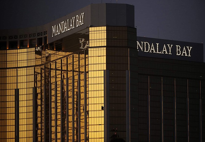 FILE - In this Oct. 3, 2017, file photo, windows are broken at the Mandalay Bay resort and casino in Las Vegas, the room from where Stephen Craig Paddock fired on a nearby music festival, killing 58 and injuring hundreds on Oct. 1, 2017. A coroner in Southern California has attributed the death of a woman to wounds she received in the Las Vegas mass shooting in October 2017. The decision by authorities in San Bernardino County would add Kimberly May Gervais to the list of 58 people killed in the deadliest mass shooting in modern American history. 