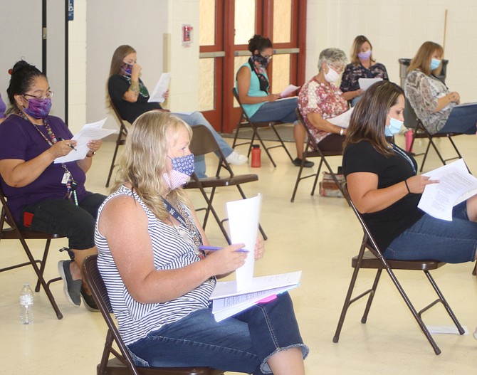 Teachers at Lahontan Elementary School receive information dealing with their students and coronavirus.