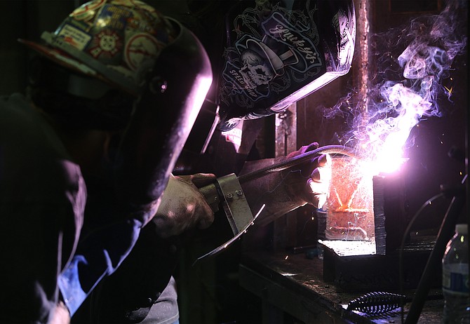 Chase Thompson watches as Candi Gray works in a welding class at Western Nevada College in Carson City, Nev., on Thursday, Sept. 14, 2017. 
Photo by Cathleen Allison/Nevada Photo Source