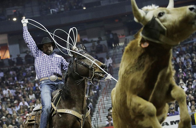 FILE - In this Dec. 10, 2016, file photo, Paul Eaves competes in the team roping event during the final night of the National Finals Rodeo, in Las Vegas. Officials announced Wednesday, Sept. 9, 2020, the National Finals Rodeo won&#039;t be held in Las Vegas this year due to coronavirus restrictions and will instead move to Arlington, Texas. 