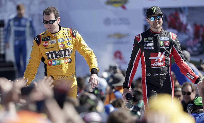 FILE - In this Feb. 18, 2018, file photo, Kyle Busch, left, and Kurt Busch, right, greet fans as they are introduced before a NASCAR Daytona 500 Cup Series auto race at Daytona International Speedway in Daytona Beach, Fla. The Busch family hobby came full circle at Las Vegas Motor Speedway, where Kurt finally won for the first time in his career Sunday, Sept. 27, 2020. The victory came about 24 hours after his nephew, Brexton Busch, won his first race at a track in North Carolina. The 5-year-old son of reigning Cup champion Kyle is being developed by Tom Busch, who molded his own two sons into NASCAR champions. 