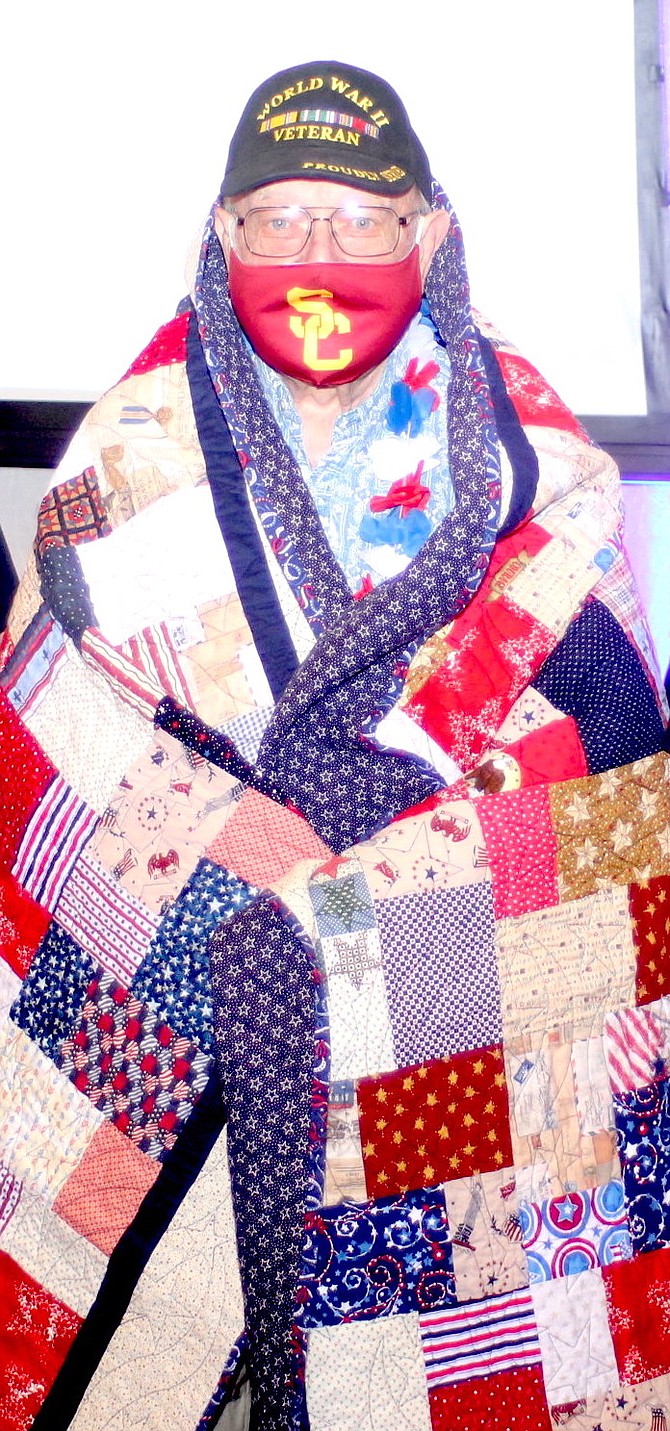 Gene Brockman of Reno displays a quilt hand sewn for him by the Comstock Lode Quilters.
