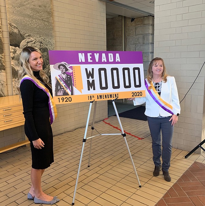 WNC student Maxine Thew, left, and Molly Walt of the Nevada Commission for Women pose with the specialty license plate they collaborated to create to commemorate the 100th anniversary of women being able to vote. The license plate can be purchased now.