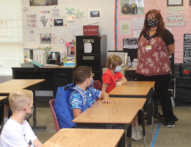 Shelby Brown, a teacher at Numa Elementary School, begins to review information with her fourth-grade students on the first day of school.