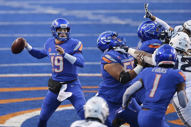 Boise State quarterback Hank Bachmeier (19) looks to throw the ball against the Utah State defense in the first half of an NCAA college football game Saturday, Oct. 24, 2020, in Boise, Idaho. 
