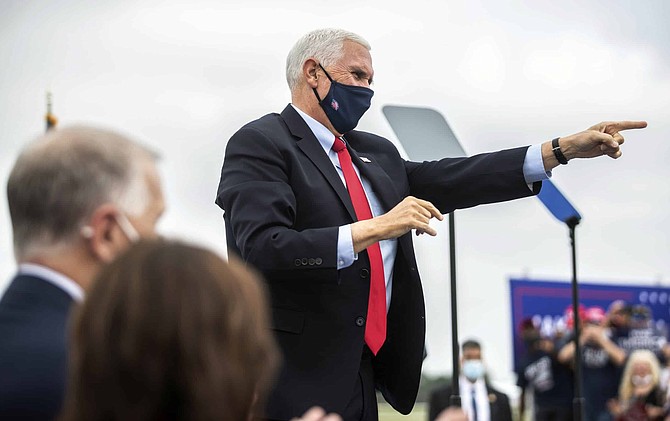 Vice President Mike Pence points to the crowd during a campaign event at the Piedmont Triad International Airport in Greensboro, N.C., Tuesday, Oct. 27, 2020. 