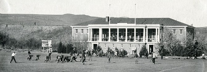 The 1920 football game between Nevada and the University of California, Berkeley on Mackay Field with the Mackay Training Quarters in the background.