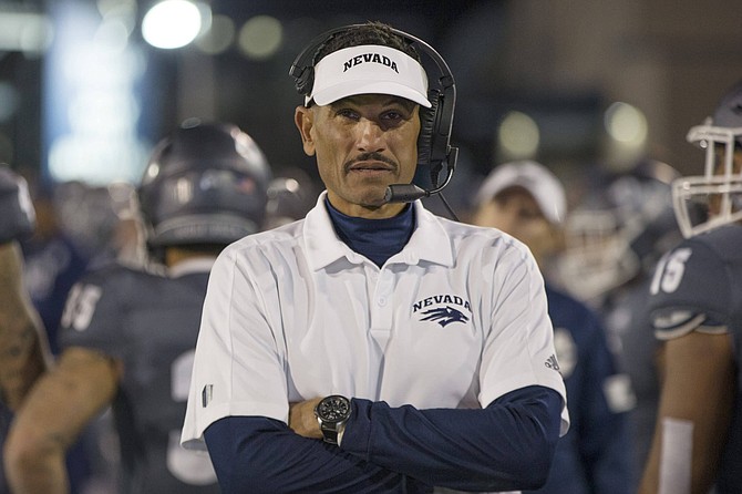 FILE - In this Nov. 2, 2019, file photo, Nevada head coach Jay Norvell works the sideline during the second half of an NCAA college football game against New Mexico in Reno, Nev. Colleges around the country finished off their football signing classes this week, proudly touting scores of African-American athletes as their next big stars. A review of all 130 FBS schools found shockingly low numbers, with blacks still largely shut out of head coaching positions and even more so the prime coordinator spots.    (AP Photo/Tom R. Smedes, File)