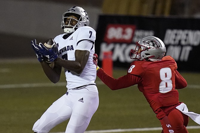Nevada wide receiver Romeo Doubs (7) catches a pass for a touchdown over New Mexico cornerback Donte Martin (8) during the second half of an NCAA college football game Saturday, Nov. 14, 2020, in Las Vegas. 