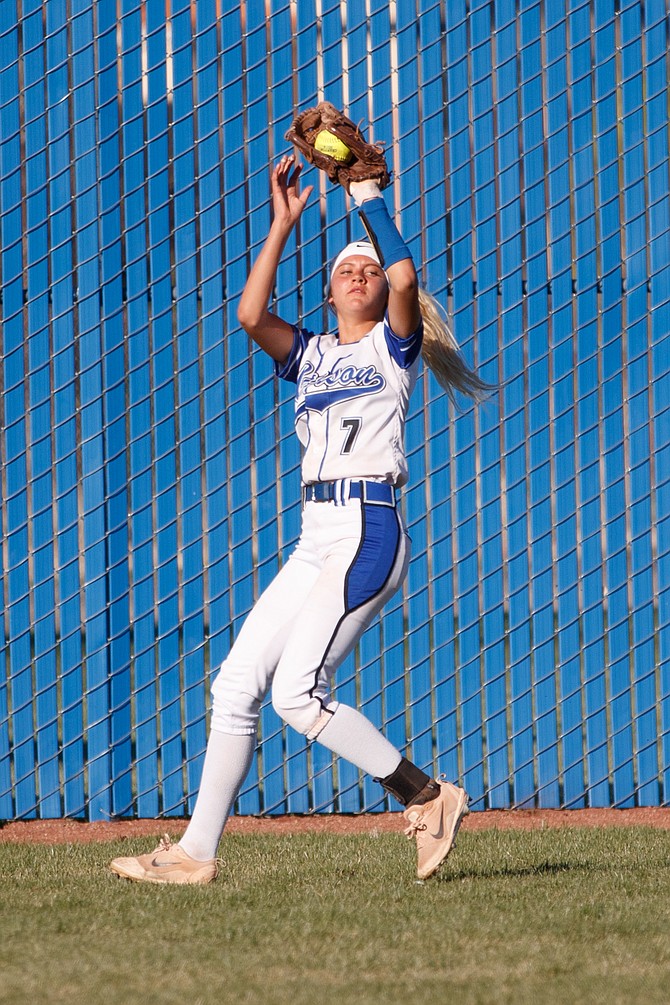 Carson Senator Kedre Luschar catches a fly ball and looks for the runner during a NIAA League game at Carson High School. 