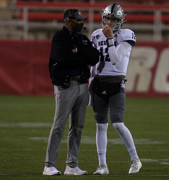 Nevada football head coach Jay Norvell talks with his starting quarterback Carson Strong Friday in Las Vegas where the Wolf Pack lost to the San Jose state Spartans. 
