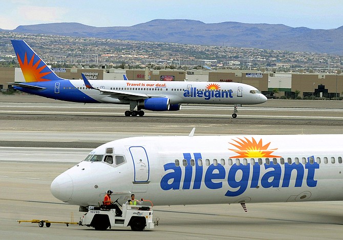 File - In this May 9, 2013, file photo, two Allegiant Air jets taxi at McCarran International Airport in Las Vegas. Federal safety regulators want to fine Allegiant Air more than $715,000, saying the discount airline failed to properly fix an engine that put out hotter-than-normal exhaust fumes. Allegiant says that it followed a procedure approved by the manufacturer and the government. (AP Photo/David Becker, File)
