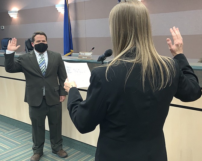 Churchill County Clerk Linda Rothery administers the oath Monday morning to Dr. Justin Heath, who was elected to the commission last year.
