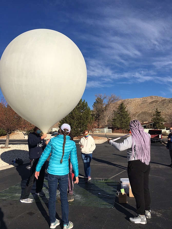 Western Nevada College students prepare a high altitude balloon for its launch on Dec. 4 at Jack C. Davis Observatory.