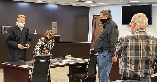 Tahoe Township Justice of the Peace Richard Glasson and Clerk-Treasurer Kathy Lewis prepare for a card draw on Wednesday morning. 