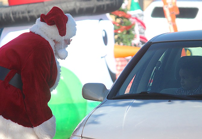 Santa has a chat with a child on Monday at the drive-through Cookies with Santa event in Gardnerville.