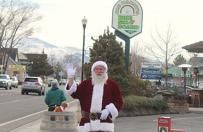 Santa waves to passers by on Main Street in Gardnerville in front of Big Daddy&#039;s Bikes and Brews.