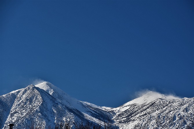 Snow blows off Jobs Peak on Tuesday as a new front arrives.