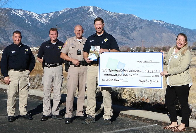 Sheriff Dan Coverley, and his now clean shaven staff, present a $3,000 check to Northern Nevada Children&#039;s Cancer Foundation.