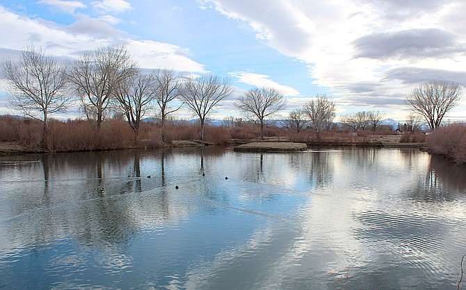 The Seeman Pond reflects clouds. Improvements on the pond could start this spring.