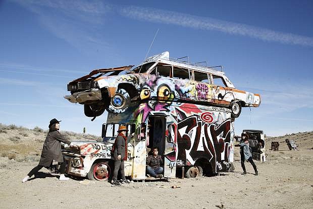 South Korean tourists explore the International Car Forest of the Last Church outside Goldfield, Nev.