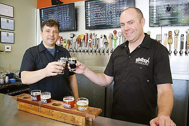 Toasting another hard day at the office are Richard Taylor (left) and Brett Schaeffer, co-owners of SixFour Growlers.