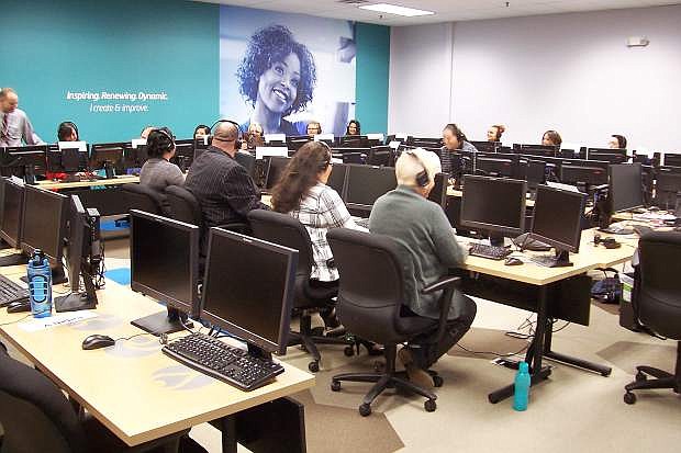 New employees learn the Teleperformance systems in one of four contact center training rooms in the new Reno location.