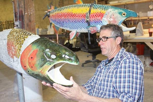 Artist Peter Hazel of Verdi checks the fit of a ceramic fish head on a sculpture in progress.