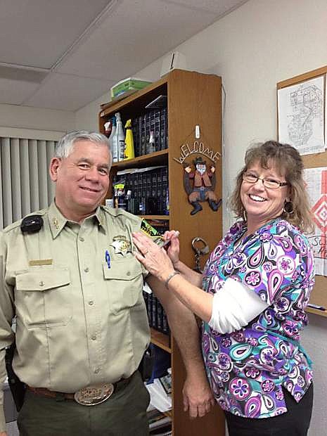 Lander County Sheriff Ron Unger receives a flu shot from nurse Brenda Keller.