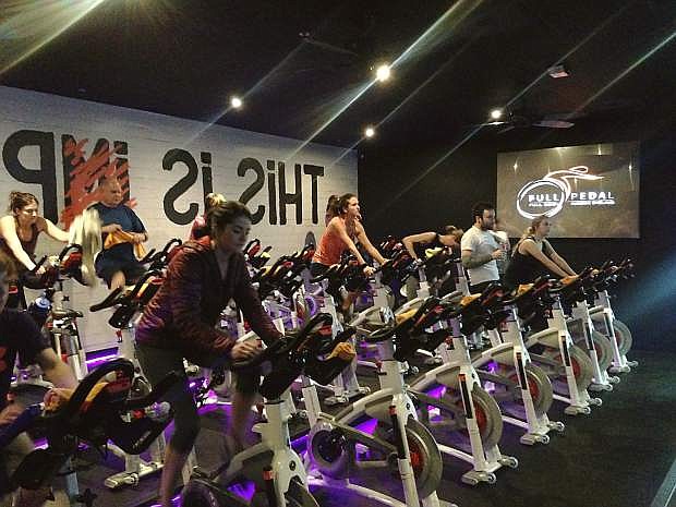 A spin class works out at Full Pedal Full Body Indoor Cycling.