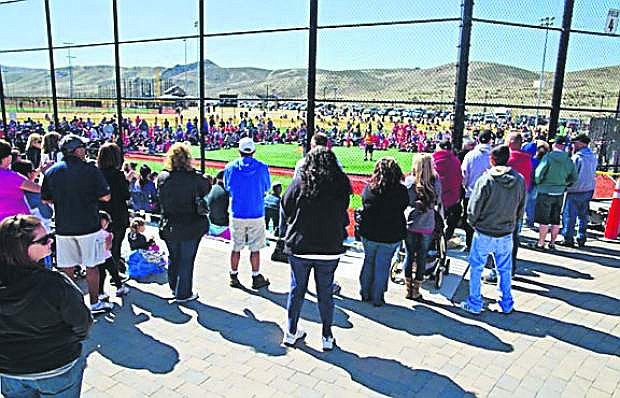 Spectators, mostly from out of state, watch during opening day of the Girls Fastpitch Softball Tournament at the Sports Complex at Golden Eagle Regional Park in Sparks.
