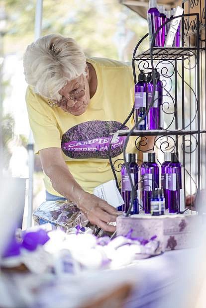 Diane van Camp of Campie&#039;s Lavender Patch arranges lavender products to sell at farmers market.