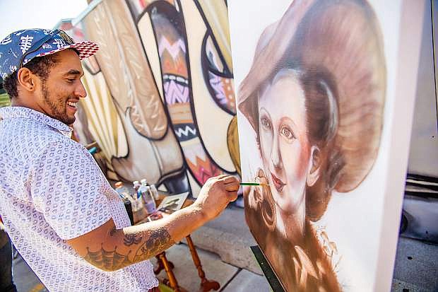 Artist Joe Crock demonstrates his artistic style during the 2015 MidTown Art Walk. Crock and fellow artist Erik Burke will be painting murals during the 2016 event.