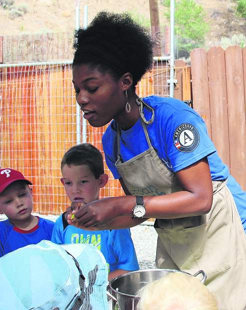 An Americorp worker teaches children about nutrition and farming at Urban Roots.