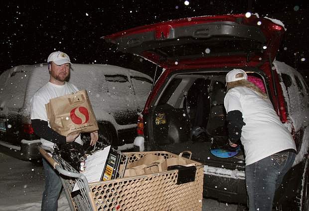 Express Lane Delivery co-owners Kyle Jordan and Amy Abernethy load groceries for a delivery on Ski Run Boulevard. Both entrepreneurs left careers in the casino industry to branch out on their own.