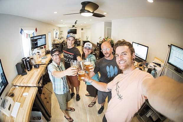 Corey Rich, left, and his production team toast their new office off of Ski Run Boulevard. Rich hopes to raise the bar on architectural standards, all while on a budget.