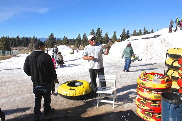 Bill Higginbotham, manager at Sierra Mountain Sports, discusses sledding tube rental rates with a customer.
