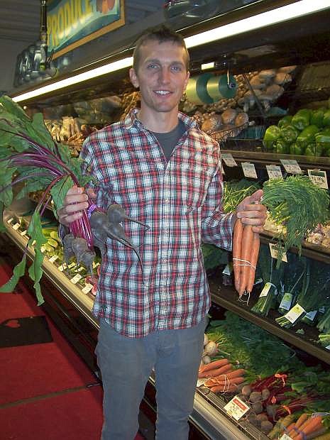 Andrew Yokum, grocery buyer for Great Basin Community Food Co-op, shows organic produce at the shop. Many of the coop&#039;s suppliers will have to seek alternative organic certification before the Nevada Department of Agriculture certification program ends next year.