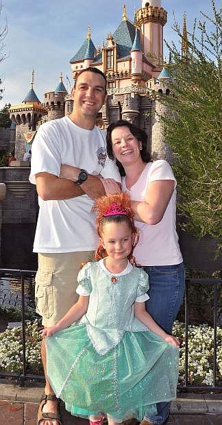 Chris Kissinger and his wife, Marie, enjoy a sunny day at Disneyland with their daughter, Calissa.