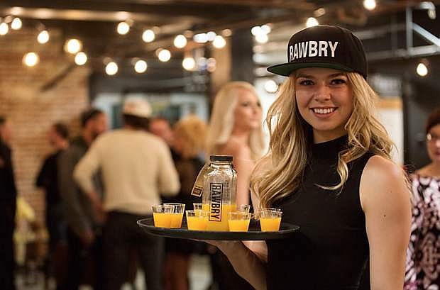 A server passes out samples of RAWBRY&#039;s juice during a grand opening celebration Feb. 20 in The Basement.